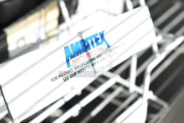 White metal rack with Ambitex Safety Disposables label. New condition, includes scratch and dent items. 