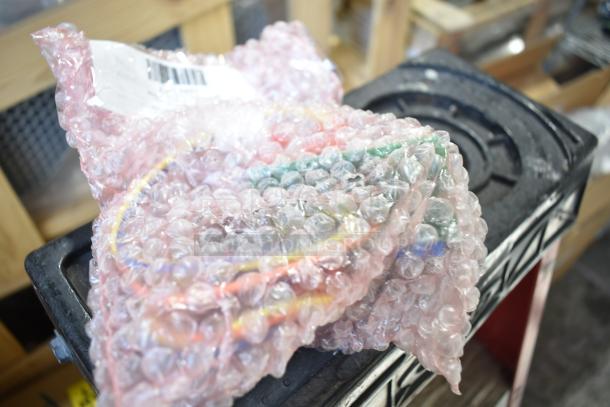 Box of various items in bubble wrap, including a Berkel blade and ignition control, labeled as "Brand New Scratch and Dent."