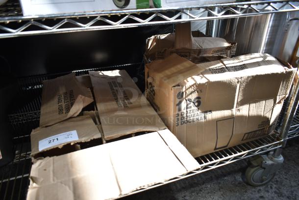 Boxes of new Acopa and Libbey glassware, including Memphis, Collins, and Irish Coffee Glasses on metal shelving.