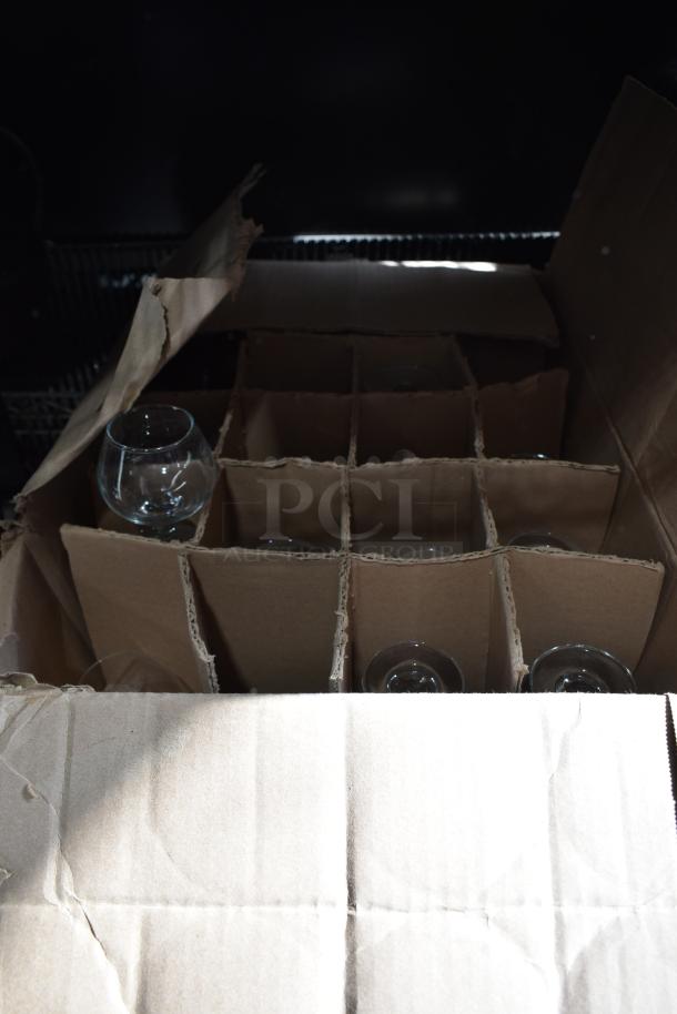 Box of new glassware, including Acopa Memphis 9 oz. glasses and Libbey customizable glasses. Slightly damaged packaging.