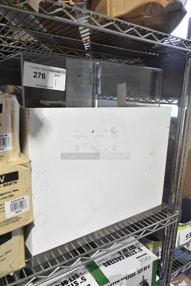 Brand new countertop dry display case merchandiser. Features minor scratches and dents, otherwise unused condition. Auction lot tag reads "276."