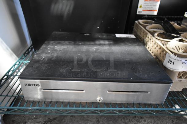Micros cash drawer, black and silver, visible wear, key lock on front, suitable for retail use, auction tag 281.