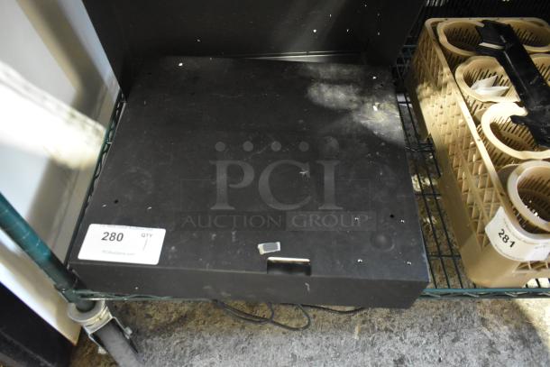 Micros cash drawer, black, metal, with visible signs of wear, auction tag "280," power cable in view.