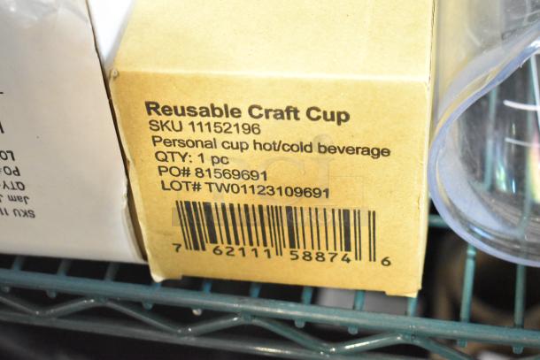 Cardboard box labeled "Reusable Craft Cup" with SKU 11152196, QTY: 1 pc, on a metal shelf.