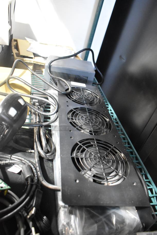 Nine assorted electronic items including a power conditioner, Amino device, remote, and Symbol barcode scanner. Cables visible.