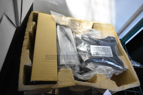 Box with 9 items including a power conditioner, remote, and Symbol barcode scanner. Items are sealed in plastic.