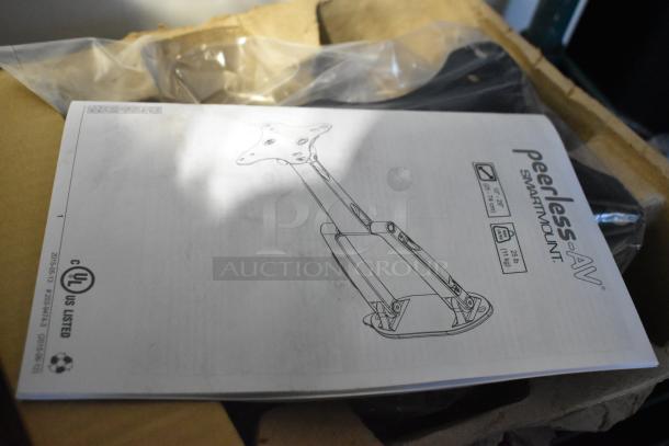 Peerless-AV SmartMount manual on top of box, showing mount illustration and specs; part of auction lot with 9 items.