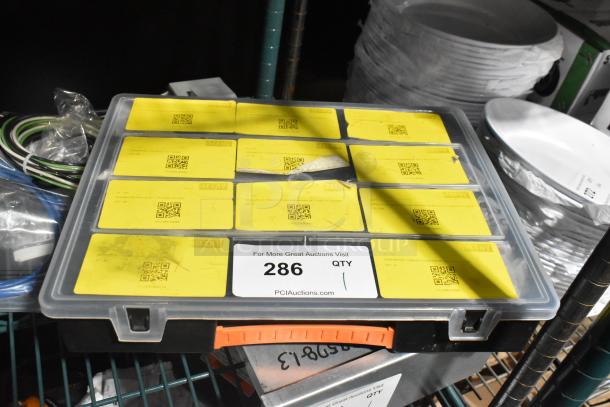 Plastic toolbox with yellow labeled compartments, filled with various tools. Label reads "286 QTY, PCIauctions.com."