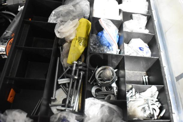 Toolbox with assorted screws, bolts, and washers in compartments. Includes labeled bags and yellow packaging with a QR code.