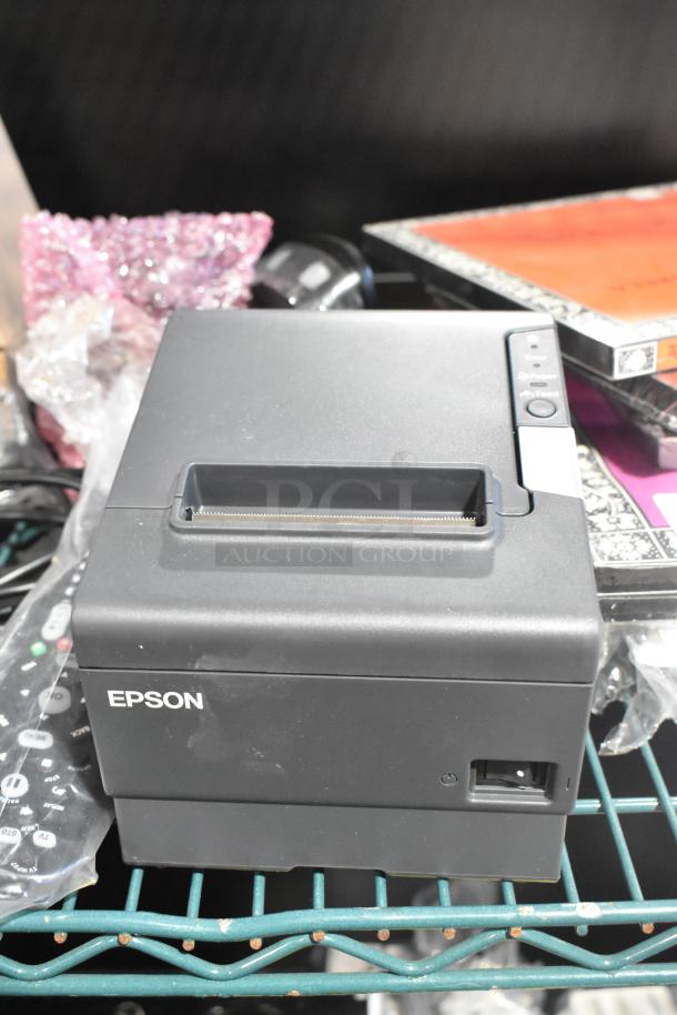 Epson M244A receipt printer, black, includes Symbol barcode scanner, remote, credit card reader; lightly used condition.