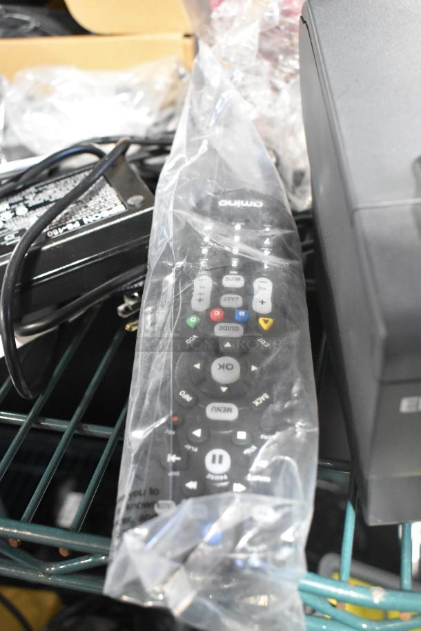 Epson M244A receipt printer, remote in plastic wrap, barcode scanner, and credit card reader on shelf.