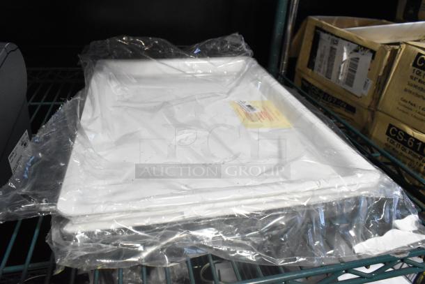 Eight white plastic trays stacked and wrapped in plastic, label with barcode visible, auction item "8 Signs. 8 Times Your Bid!"