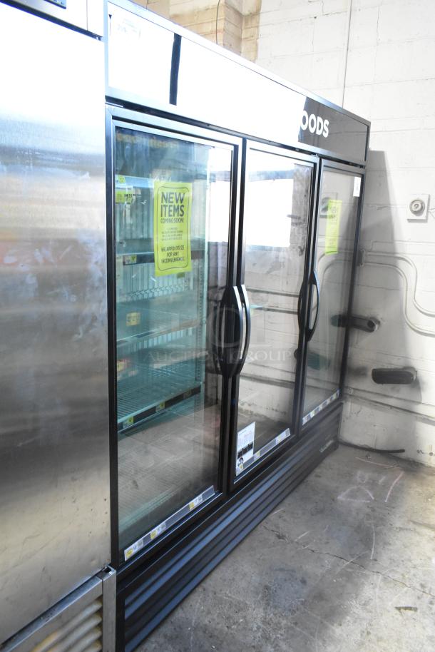 True GDM-72F-HC 3-door commercial reach-in freezer merchandiser, 115V. Features glass doors, interior shelving, and new item signage.