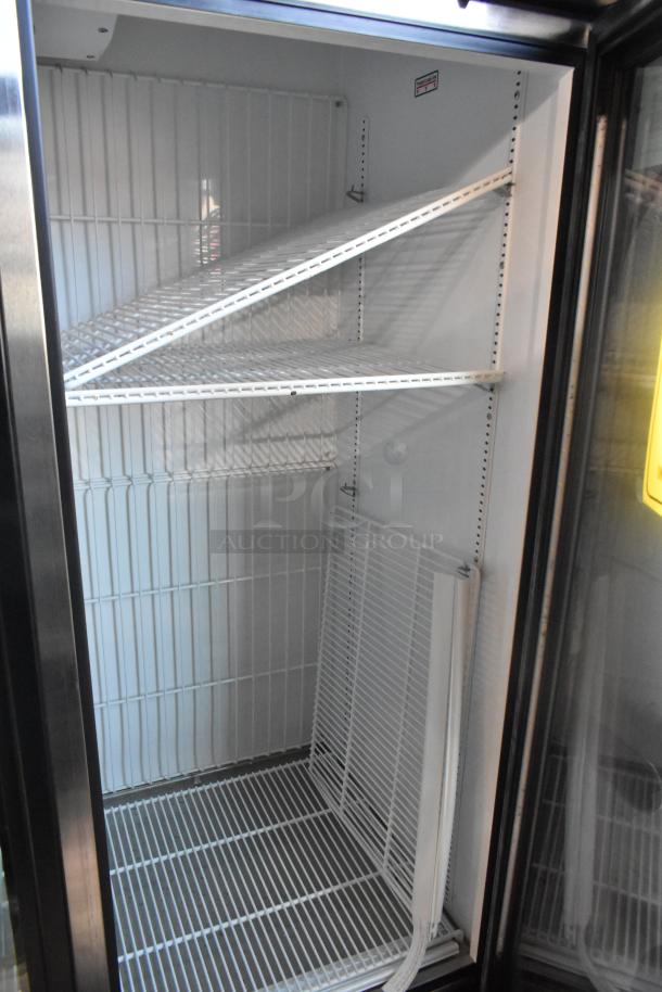 True GDM-72F-HC commercial freezer, 3 doors, 115V, 1 phase. Features adjustable wire shelves, white interior.