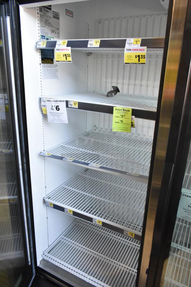 2025 True GDM-72F-HC 3 Door Reach-in Freezer Merchandiser, 115V, 1 Phase, with price tags on shelves, good condition.