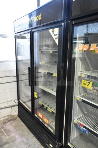 2019 True GDM-49 commercial two-door reach-in cooler, 115 volts, 1 phase, good condition, visible price tags.