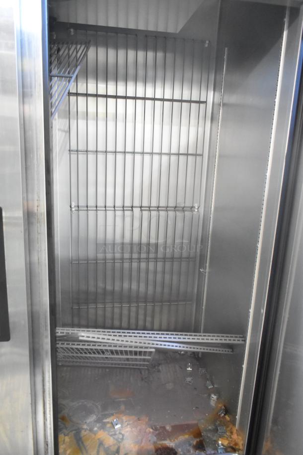 2019 True T-49F-HC Commercial 2 Door Reach-In Freezer on casters. Interior view showing metal shelves, 115V, 1 phase.