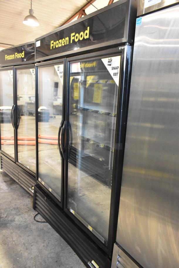 2019 True GDM-49-HC commercial 2-door cooler merchandiser, glass doors, labeled "Frozen Food," good condition.