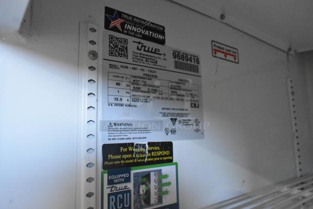2019 True GDM-49F-HC freezer merchandiser label, showing model info, voltage, refrigerant type, and maintenance warnings.