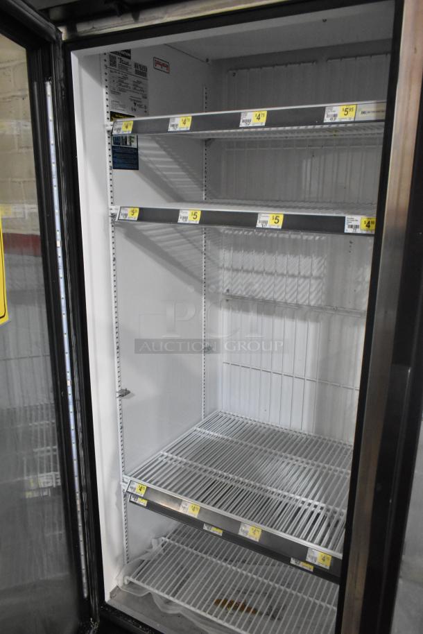 2020 True GDM-49F-HC commercial freezer, 2 glass doors, 4 shelves, model tags visible, good condition, 115/208-230 volts.