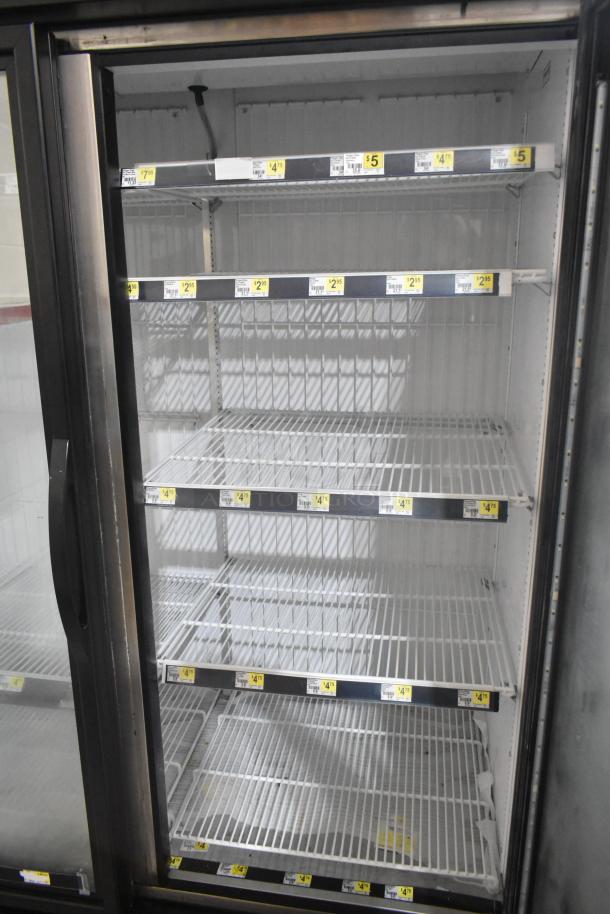 2020 True GDM-49F-HC Commercial 2 Door Freezer with glass doors, four shelves, and visible price tags.