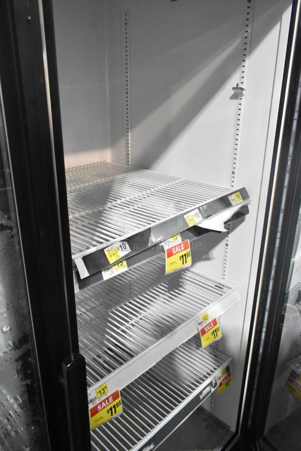 2016 True GDM-49-HC commercial 2-door reach-in cooler, used, 115V, 1 phase. Visible pricing labels on shelves.