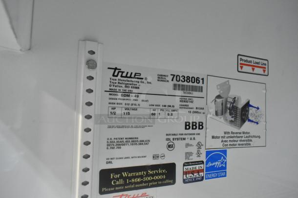 True GDM-49 cooler label, showing model, 115V, serial 7038061, R134A refrigerant details, and warranty info.
