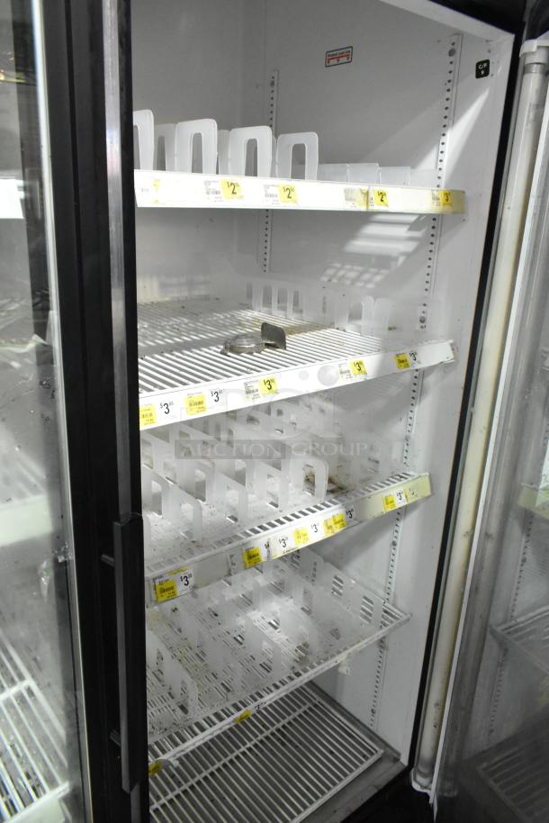 True GDM-49 commercial 2-door cooler merchandiser. Upright with multiple shelves, 115V, visible price tags, good condition.