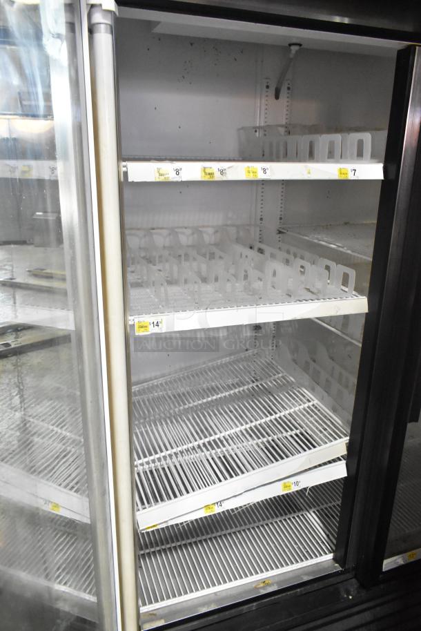 True GDM-49 Commercial 2 Door Reach In Cooler Merchandiser, 115V, visible shelves, used condition, several price labels.