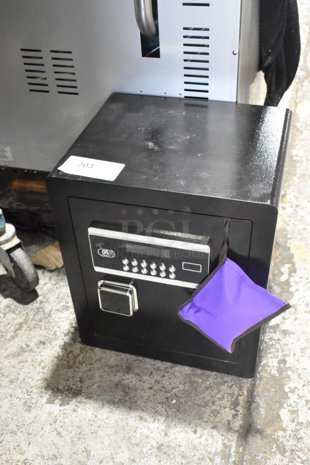 BRAND NEW SCRATCH AND DENT black single compartment safe with digital keypad and keys. Sticker labeled "303".