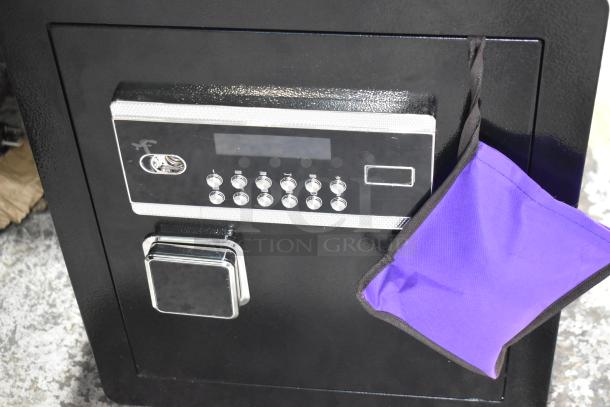 Black single compartment safe with keypad and keyhole, brand new, scratch and dent condition. Comes with keys.