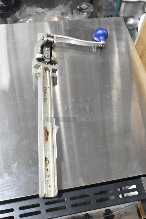 Edlund commercial can opener with blue handle, showing wear and rust on the metal bar, marked with size No. 1.