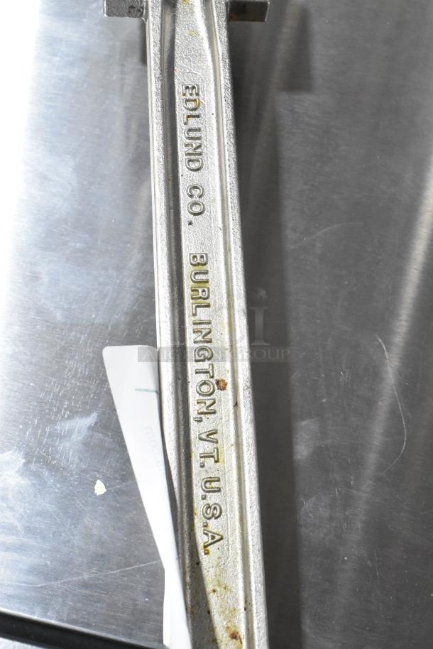 Edlund Commercial Can Opener, metal finish, marked "Edlund Co. Burlington VT USA," showing signs of use.