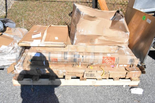 6 new scratch and dent items on a pallet, including a heated shelf warmer. Damaged boxes, visible shipping labels.