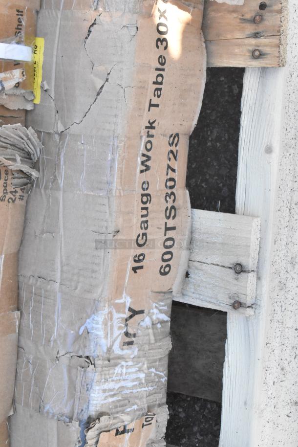 Damaged packaging of a 16-gauge work table, model 600TS3072S, part of a lot including a heated shelf warmer.