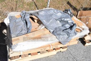 Plastic-wrapped pallet of six brand new scratch and dent items, including wire shelves. Packaging slightly damaged.