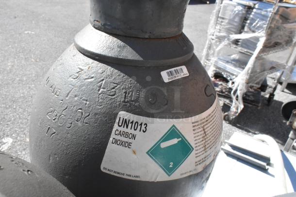 UN1013 labeled carbon dioxide tank, condition: used. Includes seven tanks total. Pickup only, no shipping.
