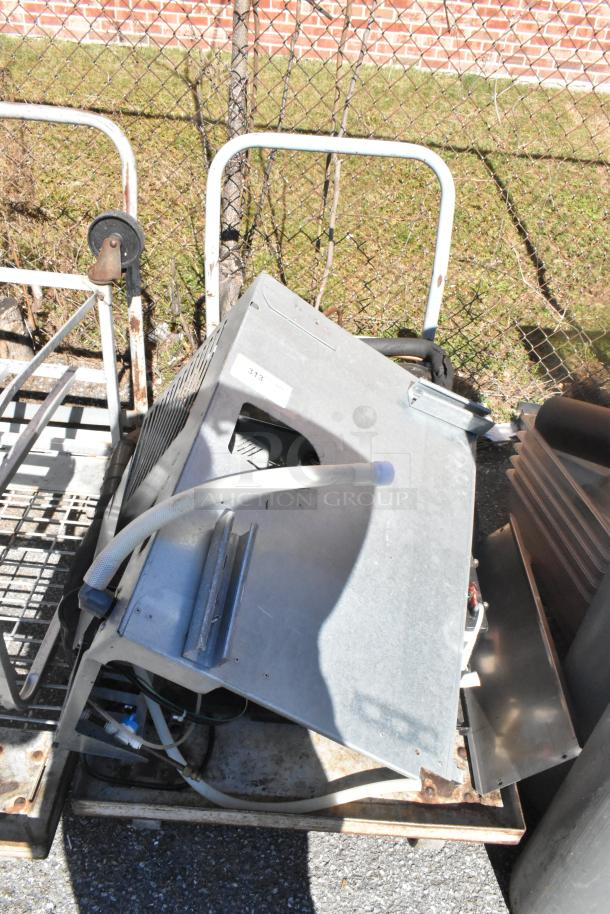 Commercial flat cart on casters with contents. Metal frame, used condition. Features metal and vented components.