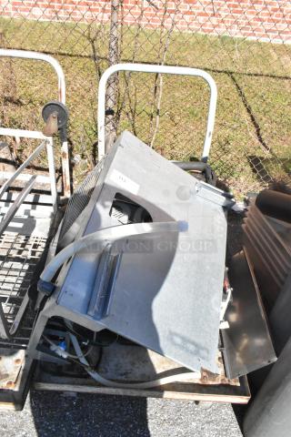 Commercial flat cart on casters with contents. Metal frame, used condition. Features metal and vented components.