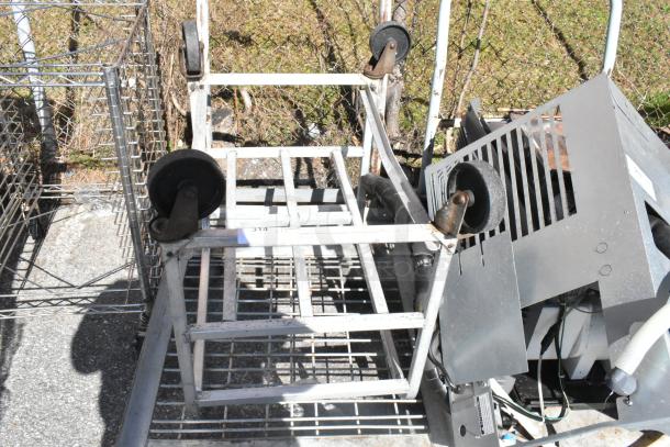 Commercial Dunnage 2 Tier Rack and Flat Cart on Casters. Metal construction, sturdy design, signs of use visible.