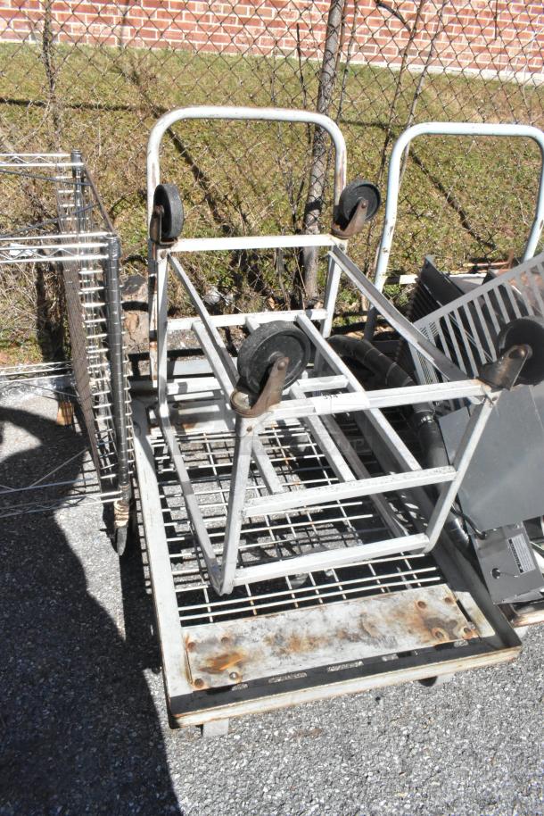 Two commercial items: Dunnage-style 2-tier rack and flat cart, both on heavy-duty casters. Used condition.