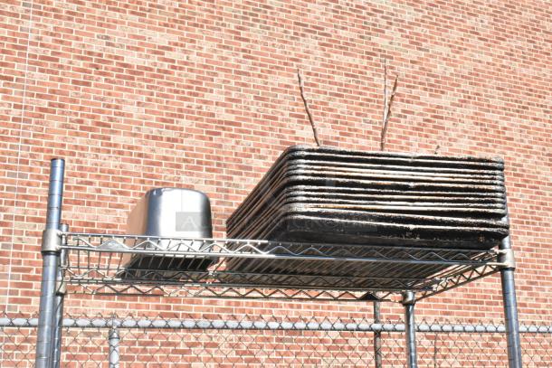 Chrome 4-tier wire shelving unit with casters, includes stainless steel drop-in bins. Buyer must dismantle; freight charges apply.