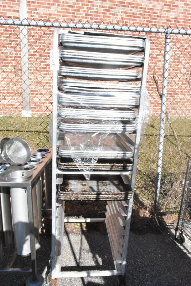 Commercial pan transport rack on casters with 30 baking pans, metal frame, used condition, label marked "317".