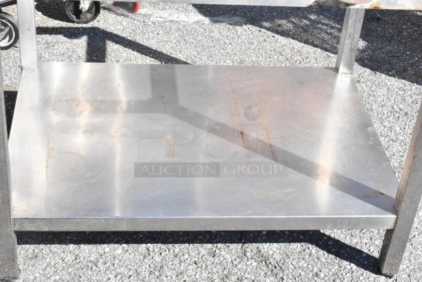 Stainless steel equipment stand with visible rust marks, sturdy frame, and caster wheels. Sold as a set of 2.