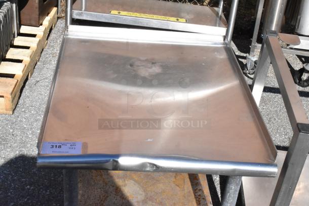 Two stainless steel equipment stands with dented surfaces on pallet. Auction tag reads "For More Great Auctions Visit PCIauctions.com, 318, QTY 2".