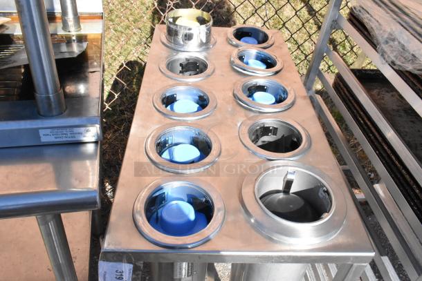 10 well cup dispenser cart with commercial casters, stainless steel body, and visible blue cup holders, in good condition.