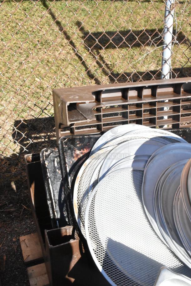 Pallet lot with poly bins, colanders, and stainless steel bins; visible scuff marks; outdoor setting.