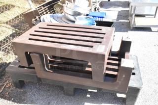 Three Poly Dunnage Racks, 2 brown, 1 black, stacked outdoors. Used condition, perfect for storage and display.