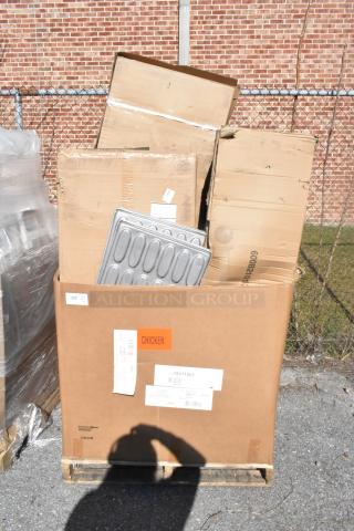 Large cardboard box containing various items, including a metal tray and several smaller boxes. Labels on the box include shipping tags and an orange "CHICKEN" sticker. Items are described as brand new with minor scratches and dents.