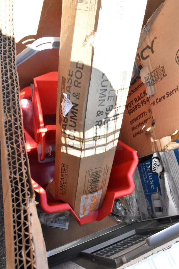 Auction items including red chafers, cardboard boxes marked "Lancaster Table & Seating," and "Pot Rack 600PS1548".